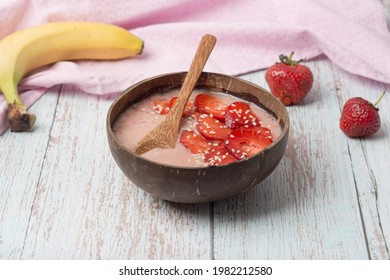 Raspberry Banana Smoothie Bowl Topped With Raspberries, Banana, Coconut And Goji Berries