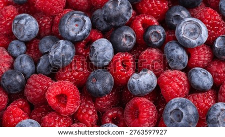 Raspberry, blueberry as a background.  Top view.