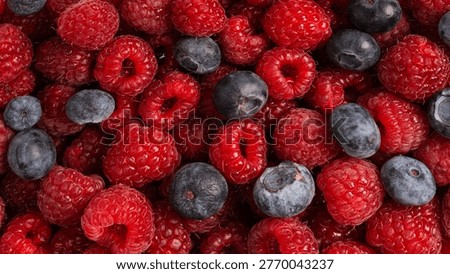 Raspberry, blueberry as a background.  Top view.