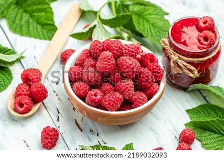 Raspberry in bowl on light background. Organic Raspberry. Red berry. top view with copy space.