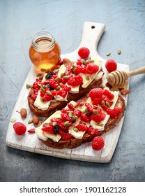 Raspberry And Brie Sourdough Bread Toast With Pumpkin Seeds And Drizzled With Honey