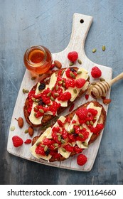 Raspberry And Brie Sourdough Bread Toast With Pumpkin Seeds And Drizzled With Honey