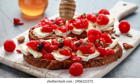 Raspberry And Brie Sourdough Bread Toast With Pumpkin Seeds And Drizzled With Honey