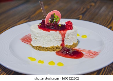Raspberry cheesecake dessert food at luxury a la carte restaurant with sauce