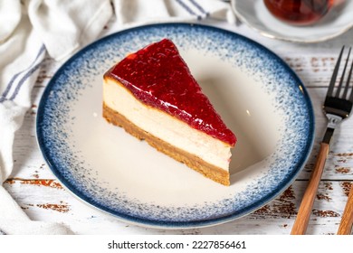 Raspberry Cheesecake on a white wooden background. New York cake. American food culture. Bakery desserts