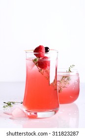 Raspberry Cocktail In A Glass With Fresh Berry And Thyme
