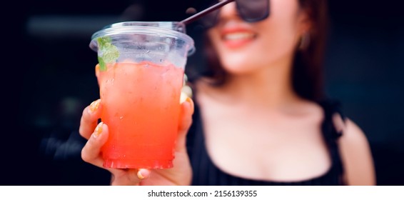 Raspberry crushed ice with mint cold refreshing cocktail.Woman holding cup cocktail gin mixed fruit in party.summer drink.bartender.World cocktail day.summer beverage fruit soda.Mojito, bar party.