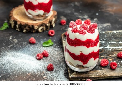 Raspberry Dessert Cheesecake, Trifle, Mouse In A Glass. Raspberry Greek Yogurt Granola Parfait On A Dark Background. Restaurant Menu, Dieting, Cookbook Recipe.