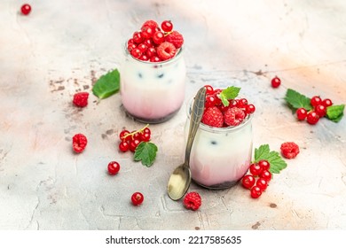 Raspberry Dessert Cheesecake, Trifle, Mouse In A Glass. Raspberry Greek Yogurt Granola Parfait On A Light Background. Restaurant Menu, Dieting, Cookbook Recipe.