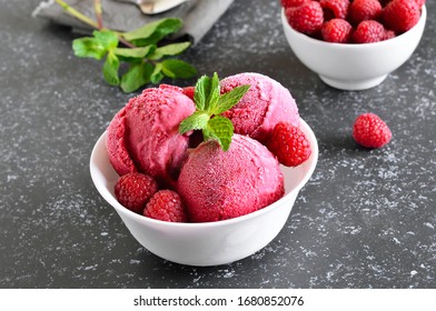 Raspberry ice cream scoop with fresh raspberries in bowl on stone background. Cold summer dessert - Powered by Shutterstock