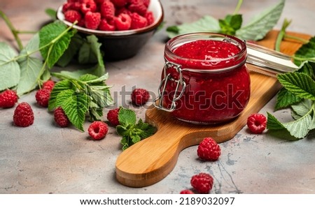 Raspberry jam with berry on light background. Homemade jam with raspberry. banner, menu, recipe place for text, top view,