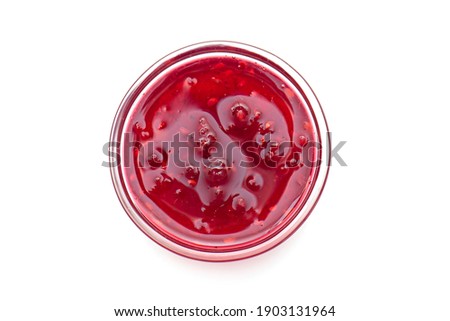Raspberry jam in glass bowl, liquid jam isolated on white, top view, lay out with space for text