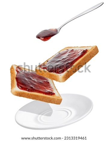 raspberry jam pouring from spoon on bread toasts in saucer isolated on white background