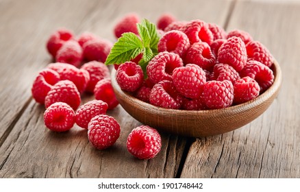 Raspberry with leaves on wooden background - Powered by Shutterstock