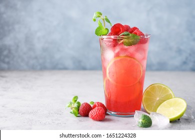 Raspberry Lemonade With Lime And Ice. Cold Refreshing Cocktail