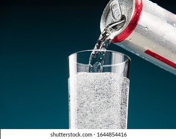 Raspberry lemonade is poured from a can into a glass - Powered by Shutterstock