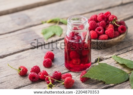 Raspberry liquor and fresh berries with leaves