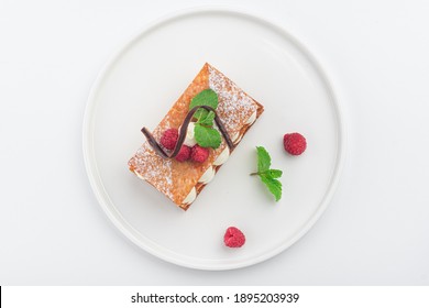 raspberry mille feuille dessert on a white plate, top view - Powered by Shutterstock