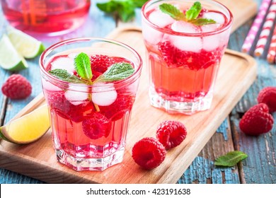 Raspberry mojito in a glass with mint and lime