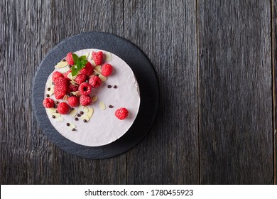 Raspberry Mousse Cake On A Slate Black Plate On A Dark Wooden Table, Landscape View From Above, Flat Lay, Free Space