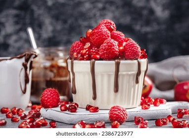 Raspberry mug cake in a red ceramic mug on dark background
