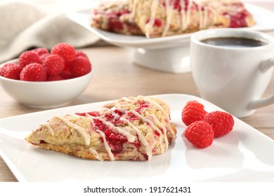 Raspberry Scone With Vanilla Frosting On Square Plate