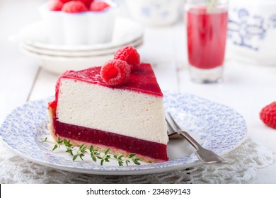 Raspberry tart, mousse cake, cheesecake with fresh raspberries on a white wooden background