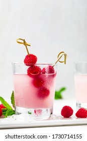 Raspberry Vodka Pink Lemonade Cocktail with Fresh Raspberry Background. Selective focus.