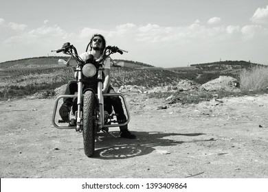 A rasta man on the chopper motorcycle.
