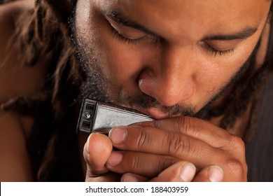 Rastafarian Man Play Mouth Harmonica