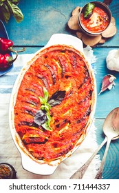 ratatouille in baking dish on a blue rustic background, top view.traditional French Provencal vegetable dish cooked in oven.Comfort autumn food.Tone.