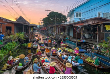 Ratchaburi, Thailand - November 15, 2020 : Peoples sell Thai cuisine on wooden boat at Damnoen Saduak Floating Market the tourists visiting by boat is popular tourist attraction on canals of Thailand.