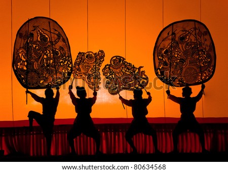 RATCHBURI, THAILAND - APRIL 13: Large Shadow Play is performed at Wat Khanon on April 13, 2011. The ancient performing art involves manipulating puppets of cowhide in front of a backlit white screen
