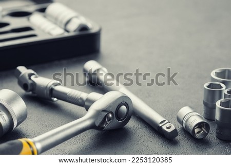 Ratchet and bits tool kit. Socket wrench and ratchet heads. Tool kit for the car on background. Equipment for auto mechanic for car repair at a service station.