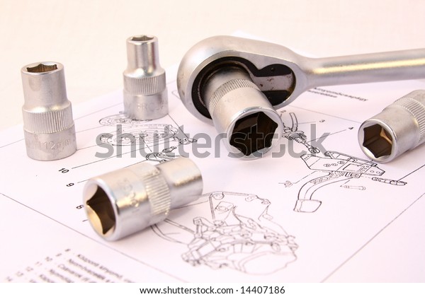 \
ratchet spanner and sockets on technical draw\
background