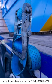 Ratchet Strap For HGV Goods Vehicle Securing A Load With The Strap On A Side Of A Semi Truck Trailer And Rolled Up Securley.