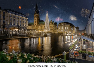 Rathaus, Christmas market, the decorated citycenter and a christmas tree. Festive atmosphere of New Year in Hamburg with fireworks. Silvester in Hamburg. Magical New Year's Eve celebrations in Hamburg