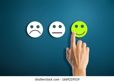 Rating concept. Woman hand choosing happy smile face emotion - Shutterstock ID 1669219519
