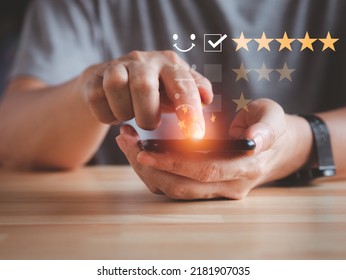 Rating Survey Concept By Man's Finger Give The Score On Mobile Phone. Five Stars Virtual Screen.