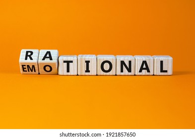 Rational or emotional symbol. Turned wooden cubes and changed the word 'rational' to 'emotional'. Beautiful orange background. Psychological and rational or emotional concept. Copy space.