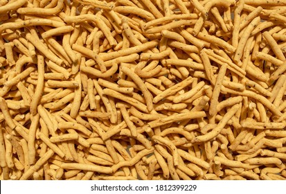 Ratlami Sev Background. Popular Gujarati Snack. Ratlami Masala Sev Backdrop. Top View. Indian Street Snack.