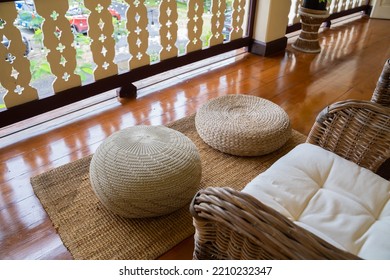 Rattan Chair And Brown Woven Circle Shape At The Wooden Balcony. 
