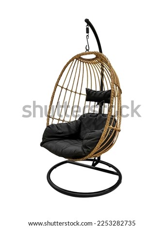 Rattan oval hanging chair with black pillow isolated on white background