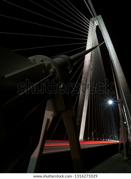 Ravenel Bridge in Charleston, SC, at night with\
car light trails