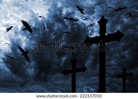 Ravens over the cemetery under a dramatic night sky