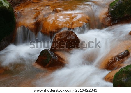 Ravine stream and the gold rocks formed by the sulphur springs, famous hot springs in Beitou, Taipei Taiwan