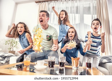 Raving Fans Cheering Sports, As Family Of Five Watch Football, Or Ice-hockey Match On The TV At Home, Screaming From Joy.