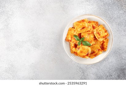 Ravioli with ricotta cheese, fresh tomato sauce and fresh basil on a gray background. Top view. Copy space - Powered by Shutterstock