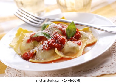 ravioli with tomato sauce and cheese garnished with basil