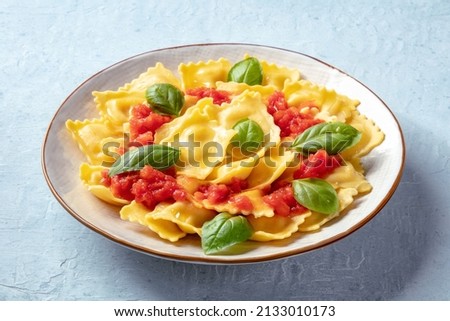 Ravioli with tomato sauce and fresh basil on a plate. Healthy Italian meal